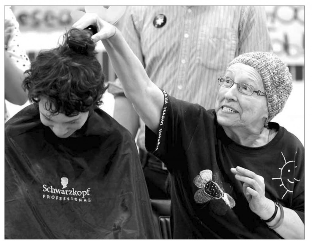 Elizabeth Grant shaves the first strip of hair off Michael Wenham, 14 at the King George School fundraiser. Wenham raised over $ 10,000 towards the Canadian Cancer Society. c. 2013 Brandon Sun archives