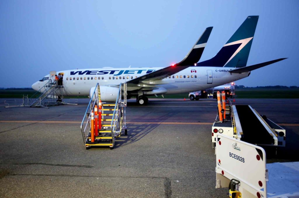 Brandon Sun 29062015 A Westjet Boeing 737 refuels at Brandon Municipal Airport at around 10:00PM  after being diverted from Winnipeg on Monday evening during an incident at Winnipeg's James Armstrong Richardson International Airport. (Tim Smith/Brandon Sun)