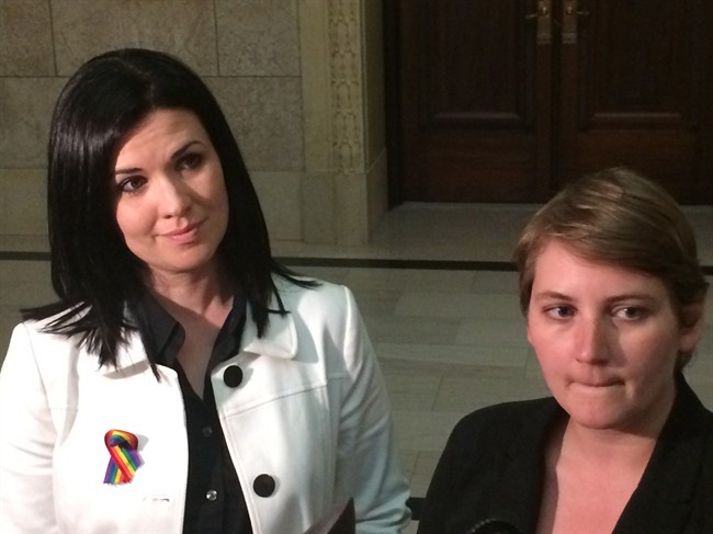 Michelle McHale, left, and her lawyer Allison Fenske, talk to reporters at the Manitoba legislature after filing a human rights complaint against the Hanover School Division, in Winnipeg on Monday, June 20, 2016. McHale says the division discriminates against same-sex persons by not allowing discussion of sexual orientation in classrooms until high school. THE CANADIAN PRESS/Steve Lambert